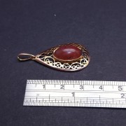 Vintage gold pendant with colored stone