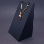 Gold pendant with colored stone