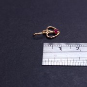 Gold pendant with colored stone