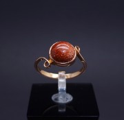 Gold ring with colored stone