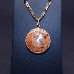 Vintage gold pendant with colored stone