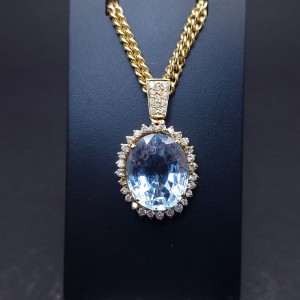 Gold pendant with diamonds and colored stone