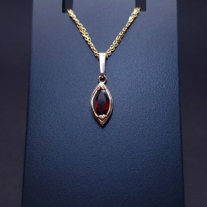 Gold pendant with colored stone