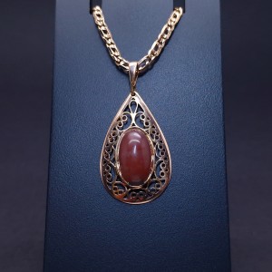 Vintage gold pendant with colored stone