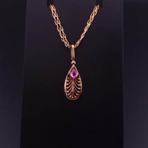 Vintage gold pendant with colored stone