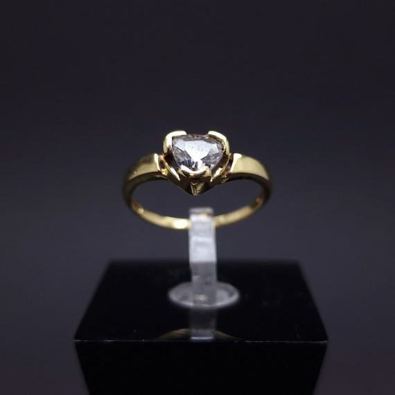 Gold ring in the shape of a heart with zircon