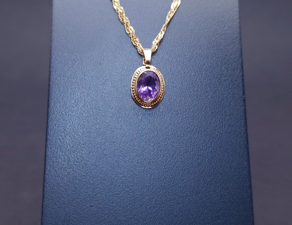 Gold pendant with colored stone